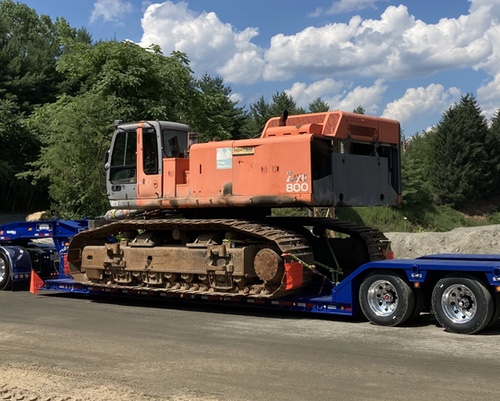 large mining excavator on trailer