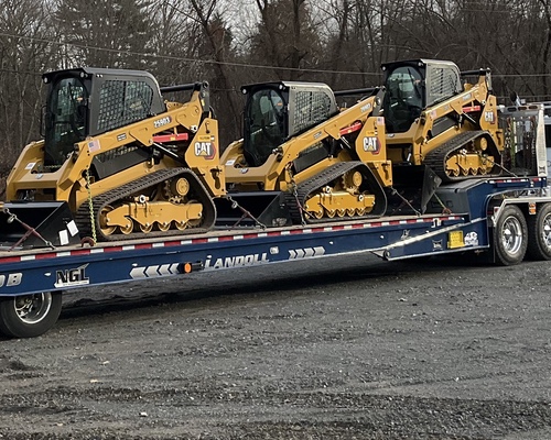 3 compact track loaders on landoll trailer